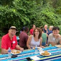 GVSU Alumni sit at picnic table at John Ball Zoo